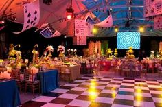 an indoor event with checkered floor and tables set up for a formal dinner or party