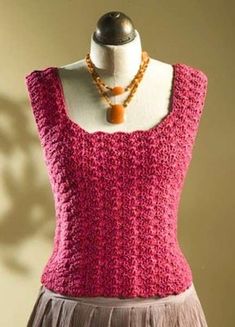 a mannequin wearing a pink top and skirt