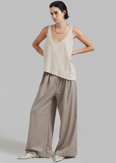 Color: Grey Lightweight fluid fabric Relaxed fit Wide leg Pleated detailing Side seam pockets Illusion welt back pocket Hook and bar closure Zip fly Unlined 75% Polyester 25% Rayon Dry Clean By The Frankie Shop. Imported The Frankie Shop, Frankie Shop, Pleated Trousers, Clothes Shop, Asymmetrical Hem, Asymmetric Hem, Round Neckline, Latest Fashion Trends, Wide Leg