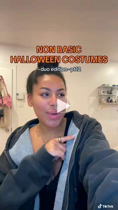 a woman pointing at the camera in front of a sign that says non basic halloween costumes