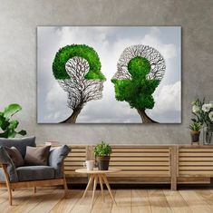 two trees with their heads in the shape of an x and y on a wall above a couch