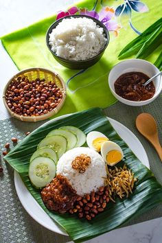 rice, beans, cucumbers, and other foods are arranged on a plate