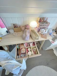 an overhead view of a desk with various items on it and a lamp in the corner