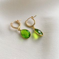 Simple and sweet, these hoop earrings feature small pear-shaped gemstone charms that are faceted on both sides. We've got gemstones for every month of the year. -- charms: 18mm 14k Gold Filled hoop diameter: 13mm secure latch back closure bezel frame: 22k gold plated sterling silver available gemstones: 12 hydrothermal quartz stones Note: moonstone - natural gemstone Green Teardrop Hoop Earrings, Green Teardrop Hoop Earrings For Everyday, Everyday Green Teardrop Hoop Earrings, Faceted Drop Teardrop Earrings For Gift, Gold Teardrop Hoop Earrings With Emerald, Gold Teardrop Hoop Earrings For May Birthstone, Elegant Teardrop Hoop Earrings With Birthstone, Elegant Teardrop Birthstone Hoop Earrings, Faceted Teardrop Earrings As Gift