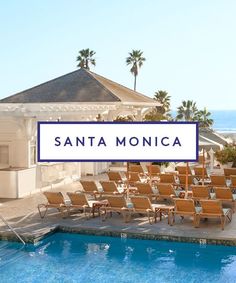 a pool with chairs and a sign that says santa monica