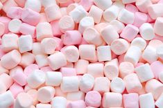 pink and white marshmallows are piled together