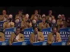 a group of men playing musical instruments in front of microphones and signs with the words gin written on them