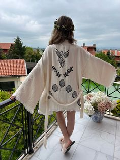 "Beautiful handmade short white Phoenix bird celestial print kimono robe, designed with cotton fabric, it flows as you move for a comfortable wear. Beach cover up, a kimono with Phoenix bird.  This is a lovely, good-quality kimono, with traditional breathable kimono sleeves.        A belt that ties around the waist. Great to wear around the house, on beaches, or to dress up with some jeans & a T-shirt, covering up on the beach with a swimsuit.         We love kimonos as they are so versatile. They also make really special & unique birthday, valentines Day, Christmas gifts, and Mother's Day gifts. The perfect combination of comfort and style, this kimono is a great addition to your new season wardrobe.    Cotton Fabric and Handmade      Length from shoulder: 75 CM Width: 130 CM Kimono Size: Coat Outfit Casual, Celestial Print, Phoenix Bird, Short Cardigan, Kimono Sleeves, Boho Kimono, Print Kimonos, Kimono Cardigan, Womens Robes