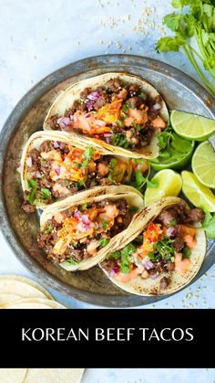 korean beef tacos on a plate with limes and cilantro