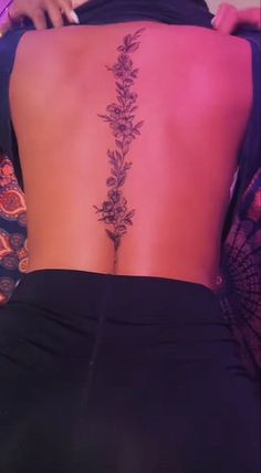 the back of a woman's body with flowers on it