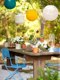 an outdoor table with chairs and potted plants on it is featured in the color palette