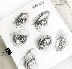 an open book with drawings of eyes on it