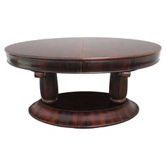 an oval wooden table with two pedestals on each side