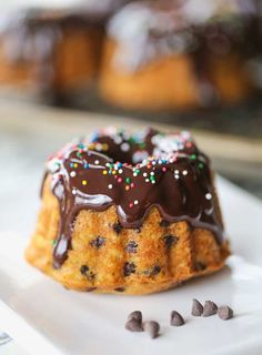 a bundt cake with chocolate frosting and sprinkles on a plate