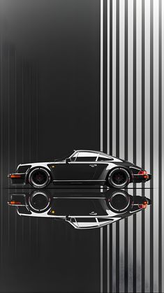 a black sports car is reflected in the water