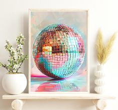 a mirror ball on a shelf next to a vase with flowers