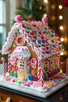 a gingerbread house decorated with candy canes and candies