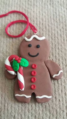 a gingerbread man ornament with candy cane