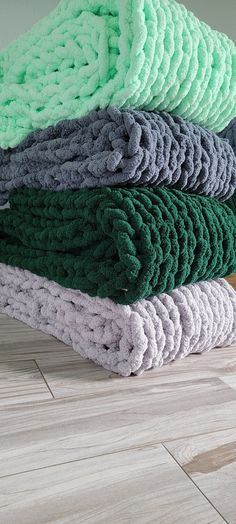 a pile of towels sitting on top of a wooden floor