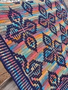 a multicolored rug is laying on the ground