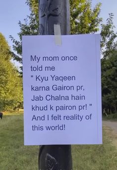 a sign attached to a pole in the grass that says, my mom once told me