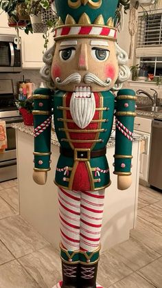 a large nutcracker standing in the middle of a kitchen