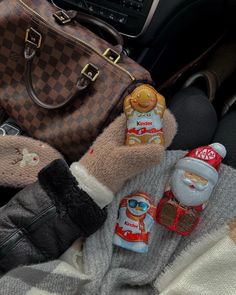 a handbag, purse and other items are sitting on the floor next to someone's feet