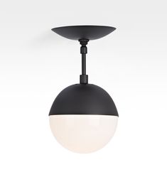 a black and white light hanging from the ceiling