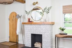 a living room with a fireplace and mirror