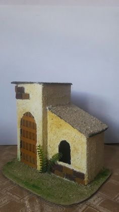 a small model house with a door and window