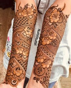 two hands with henna tattoos on them