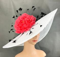 Gorgeous Kentucky Derby Hat   Ready to ship  100% Brand New  Designed & Made in USA         This gorgeous hat has a 22.5 inches interior crown circumference.The Brim is 5 3/4 inches. It fits most! Hat Base Color: White  Flower color: Hot coral Peony flower with black feathers  Black Lace hat band This is a high quality wide brim hat with wire which could hold it's shape.It won't flop in the eyes and face. Would be great for Wedding, Bridal Shower, Tea Party, Concert,Evening Wear, Belmont,Ascot, Coral Peony, Bridal Shower Tea Party, Lace Hat, Tee Party, Coral Peonies, Hat Base, Bridal Shower Tea, Elegant Hats, Kentucky Derby Hats