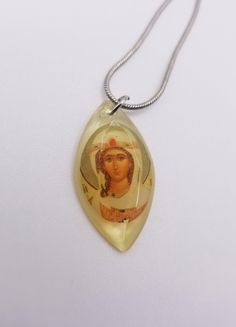 Subtle and beautiful, these miniature pendant necklaces feature traditional Orthodox Christian icons.  Each miniature icon is set in a hand-poured resin pendant and hangs on an 18-inch, 925 silver-plated snake chain with a lobster clasp.  The pendants are slightly longer than one inch. More options available in our shop! www.pocketprayercloset.com  Each piece of jewelry from Pocket Prayer Closet is individually handmade.  Artwork for these pieces sourced from 6dogarts. Engraved Pendant Necklace Souvenir, Spiritual Pendant Necklaces As Souvenirs, Spiritual Pendant Necklace For Souvenir, Yellow Round Pendant Necklace As Gift, Yellow Round Pendant Necklace For Gift, Symbolic Oval Charm Necklaces, Symbolic Oval Necklaces With Charms, Symbolic Oval Pendant Jewelry For Gifts, Oval Amber Necklace For Gift