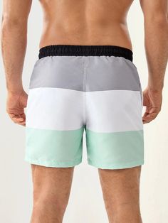 Upgrade your swimwear collection with our Three Tone Striped Print Swim Shorts. These swim shorts feature a stylish Three -tone design with contrasting stripes that add a modern and eye-catching element to your beach or pool look. The quick-drying and lightweight fabric ensures maximum comfort, allowing you to enjoy your time in and out of the water. Details: Pattern Type: Striped Details: Drawstring, Pocket Type: Bottoms Bottom Type: Shorts Fabric: Non-Stretch Composition: 100% Polyester Care I Summer Striped Color Block Swimwear, Casual White Color Block Swimwear, Striped Color Block Swimwear For Vacation, White Swimwear With Contrast Stripes For Swimming, Sporty Striped Swimwear For Beach Season, Beach Season Color Block Beachwear Bottoms, Sporty White Swim Trunks For Pool, White Color Block Bottoms For Summer, Color Block Swim Trunks For Beach