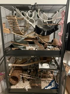 a bird cage filled with lots of different types of items on top of each other