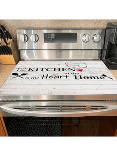 the kitchen is in the heart of home sign on the oven door and stove top