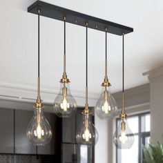 an image of a kitchen light fixture with five bulbs hanging from it's ceiling