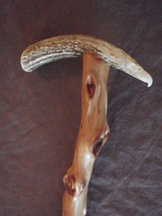 a carved wooden object with an animal's head on it