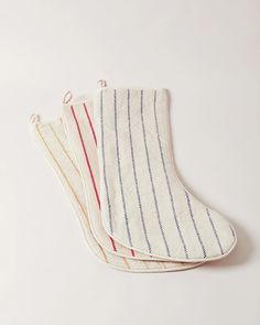 three striped oven mitts sitting on top of each other