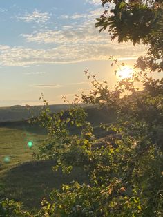 the sun shines brightly over an open field