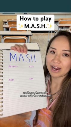 a girl holding up a notepad with the word mash written on it in front of her