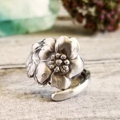 Delight in the elegance of nature with this dainty handmade sterling silver spoon ring adorned with intricately crafted wild rose blooms. Wild roses, often referred to as Rosa canina or dog roses, are celebrated for their simple yet captivating beauty and their ability to thrive in the wild, symbolizing spiritual growth and love. In art and culture, they represent an ideal of organic beauty and grace, often depicted in paintings, poetry, and literature as emblems of pure affection and enduring passion. This lovely ring would make a striking statement piece or a beautiful gift for someone you adore! This ring is made from a vintage sterling silver spoon, 925, nickel-free. This ring will be adjusted to the size you request but it can easily be tightened or loosened at home should you want a Silver Nature-inspired Open Flower Ring, Nature-inspired Silver Open Flower Ring, Nature-inspired Silver Flower Ring For Anniversary, Dog Rose, Sterling Silver Spoon Ring, Sterling Silver Spoons, Floral Rosa, Spoon Ring, Spoon Rings