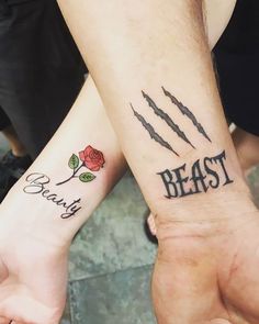 two people holding hands with tattoos on their arms and the words beast, beauty and roses