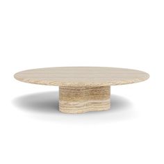 a round wooden table sitting on top of a white floor