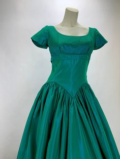 1950's formal in green & aqua iridescent taffeta. This dress is perfect for a formal event, even as a dressy cocktail dress. It has a fitted bodice, with a swooping neckline and an interesting drop waistline. There is a size zipper as a closure, that works great. The skirt is long and flowing. This garment is in EXCELLENT VINTAGE CONDITION.. no real issues to note. There is no maker or size label inside this dress. By the measurements, I would say that this dress is a WOMEN'S SIZE SMALL To b Green Taffeta Dress For Formal Occasions, Green Taffeta Dress With Fitted Bodice, 1950s Style Green Formal Dress, Green 1950s Style Formal Dress, Green Full Skirt Dress For Formal Occasions, 1950s Formal Dress, Formal Dress Green, Dressy Cocktail Dress, 24 Inch Waist