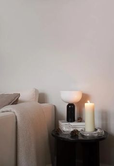 a living room with a couch, coffee table and candle