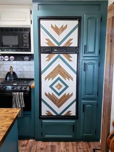 a kitchen with green painted cabinets and wood flooring on the walls, along with a black stove top oven