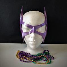 DESCRIPTIONGo retro! A lightweight purple leather mask for your '90s Catwoman Cosplay costume. Great Halloween Mask. Waterproofed leather, glossy or matte finish, & several choices to affix the mask (cord, elastic, ribbon, waterproof cord, stick, or no holes for adhesive). Measurements: 13" high x 11" wide (tallest & widest points); 0.5" high between the eyes; 2.5" wide x 2" tall eye openings ---------------------------------------------------------------------------- ALL OF OUR MASKS AR Mardi Gras Mask For Cosplay, Purple Costume Accessories For Costume Party And Cosplay Events, Purple Masks And Prosthetics For Halloween Masquerade, Purple Halloween Masquerade Masks And Prosthetics, Purple Mardi Gras Costume Accessories, Purple Themed Party Costume Accessories, Purple Mask For Costume Party, Themed Costume Accessories For Mardi Gras Cosplay, Purple Halloween Mask And Prosthetics