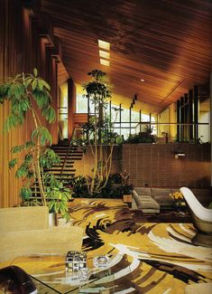 a living room filled with furniture and plants