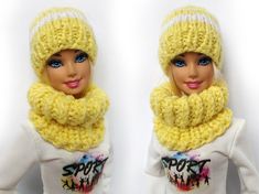 two dolls wearing yellow hats and scarves